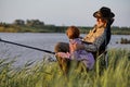 Fishing for pike, perch, carp. Skilled senior Fisherman and child with rod, fishing Royalty Free Stock Photo