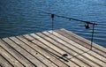 Fishing pole on pier Royalty Free Stock Photo