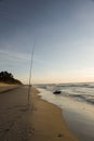 Fishing pole in sand on beach Royalty Free Stock Photo