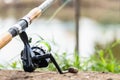 Fishing reel and rod in fisherman hand in a pond Royalty Free Stock Photo