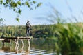 Fishing in river.A fisherman with a fishing rod on the river bank. Man fisherman catches a fish pike.Fishing, spinning reel, fish Royalty Free Stock Photo