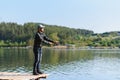 Fishing in river.A fisherman with a fishing rod on the river bank. Man fisherman catches a fish pike.Fishing, spinning reel, fish Royalty Free Stock Photo