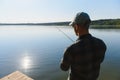 Fishing in river.A fisherman with a fishing rod on the river bank. Man fisherman catches a fish pike.Fishing, spinning reel, fish Royalty Free Stock Photo