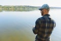 Fishing in river.A fisherman with a fishing rod on the river bank. Man fisherman catches a fish pike.Fishing, spinning reel, fish Royalty Free Stock Photo