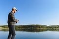 Fishing in river.A fisherman with a fishing rod on the river bank. Man fisherman catches a fish pike.Fishing, spinning reel, fish Royalty Free Stock Photo