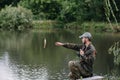 Fishing in river.A fisherman with a fishing rod on the river bank. Man fisherman catches a fish pike.Fishing, spinning Royalty Free Stock Photo