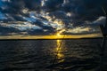 Fishing road silhouette during sunset. Fishing pole against ocean at sunset. Fishing rod in a saltwater boat during fishery day in Royalty Free Stock Photo