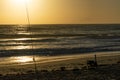 Fishing rod and beach chair on the beach at sunrise Royalty Free Stock Photo