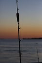 Fishing rod with blurred scene of sunset Royalty Free Stock Photo
