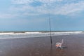 Fishing rod and empty beach chair on the seashore. Royalty Free Stock Photo