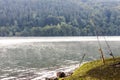 Fishing rod equipment on a lake in misty spring morning Royalty Free Stock Photo