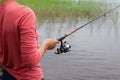 Fishing rod with a fishing reel in a woman`s hand Royalty Free Stock Photo