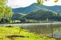 Fishing rod that is implanted on the ground at the Reservoir. Royalty Free Stock Photo