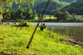 Fishing rod that is implanted on the ground at the Reservoir. Royalty Free Stock Photo