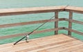 Fishing rod leaning on wood railing