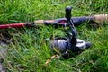 A fishing rod lying in the grass