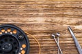 Fishing rod with orange thick fishing line and fishing tool on wooden background Royalty Free Stock Photo