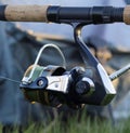 Fishing rod and reel for catching fish close-up on a blurry background. Inertia-free reel and fishing line.
