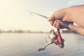 Fishing rod and reel hand holding. Shallow depth of field. Royalty Free Stock Photo