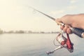 Fishing rod and reel hand holding. Shallow depth of field. Royalty Free Stock Photo