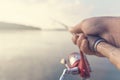 Fishing rod and reel hand holding. Shallow depth of field. Royalty Free Stock Photo