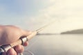 Fishing rod and reel hand holding. Shallow depth of field. Royalty Free Stock Photo