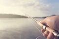 Fishing rod and reel hand holding. Shallow depth of field. Royalty Free Stock Photo