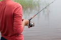 Fishing rod with a fishing reel in a woman`s hand Royalty Free Stock Photo