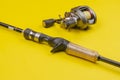 Fishing rod and reel on a yellow background