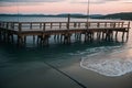 A fishing rod resting on a wooden pier