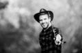 Fishing rod selective focus. happy fisherman in hat blurred. western portrait. Vintage style man. Wild West retro cowboy Royalty Free Stock Photo