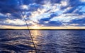 Fishing rod silhouette during sunset. Fishing pole against ocean at sunset. Fishing rod in a saltwater boat during fishery day inF Royalty Free Stock Photo