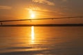 Fishing rod spinning with the line close-up. Fishing rod over gold orange sunset over the lake. Fishing rod rings Royalty Free Stock Photo