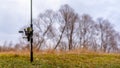 Fishing rod spinning reel stands on the background of the field. Royalty Free Stock Photo