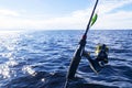 Fishing on the lake. Hands of fisherman with fishing rod. Macro shot. Fishing rod and hands of fisherman over lake water. Spinning Royalty Free Stock Photo