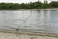 The fishing rod stands at a stop near a picturesque river.