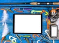 Fishing rod, tackles and fishing baits, reel on wooden board background with tablet computer isolated white screen, empty space