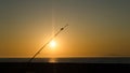 Fishing rodes  pointing at sunset on Newport Beach pier Royalty Free Stock Photo