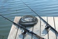 Fishing rods and fresh fish on wooden pier pond Royalty Free Stock Photo