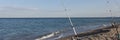 Fishing rods on sea beach, seashore landscape. Royalty Free Stock Photo