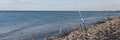 Fishing rods on sea beach, seaside landscape Royalty Free Stock Photo
