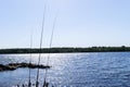 Fishing rods silhouette during sunset. Fishing pole against ocean at sunset. Fishing rod in a saltwater boat during fishery day in Royalty Free Stock Photo