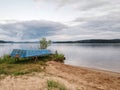 Fishing rowing boat stacked on steel racks at big pond Royalty Free Stock Photo