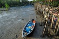 Fishing sampan stranded near to wooden pier