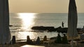 Fishing by the sea at sunset