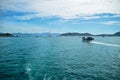 Fishing seiner returns to the port, against the backdrop of zaoiva, ships, cable car, mountains and clouds Royalty Free Stock Photo