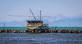 Fishing shack to trawl the estuary, with mountains behind