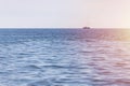 Fishing ship at sea. Lonely boat trawler goes to port for sell fish catch. Calm clear sunny weather. Beautiful horizon of seascape Royalty Free Stock Photo