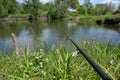 Fishing by a small pond view from a fisherman