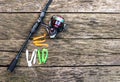 Fishing accessories, spinning, fishing reel, silicone lures on a wooden background Royalty Free Stock Photo